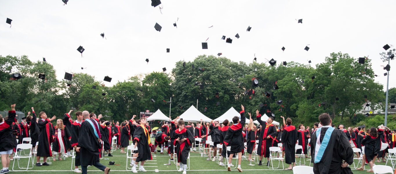 rye high school graduates throw their hats in the air